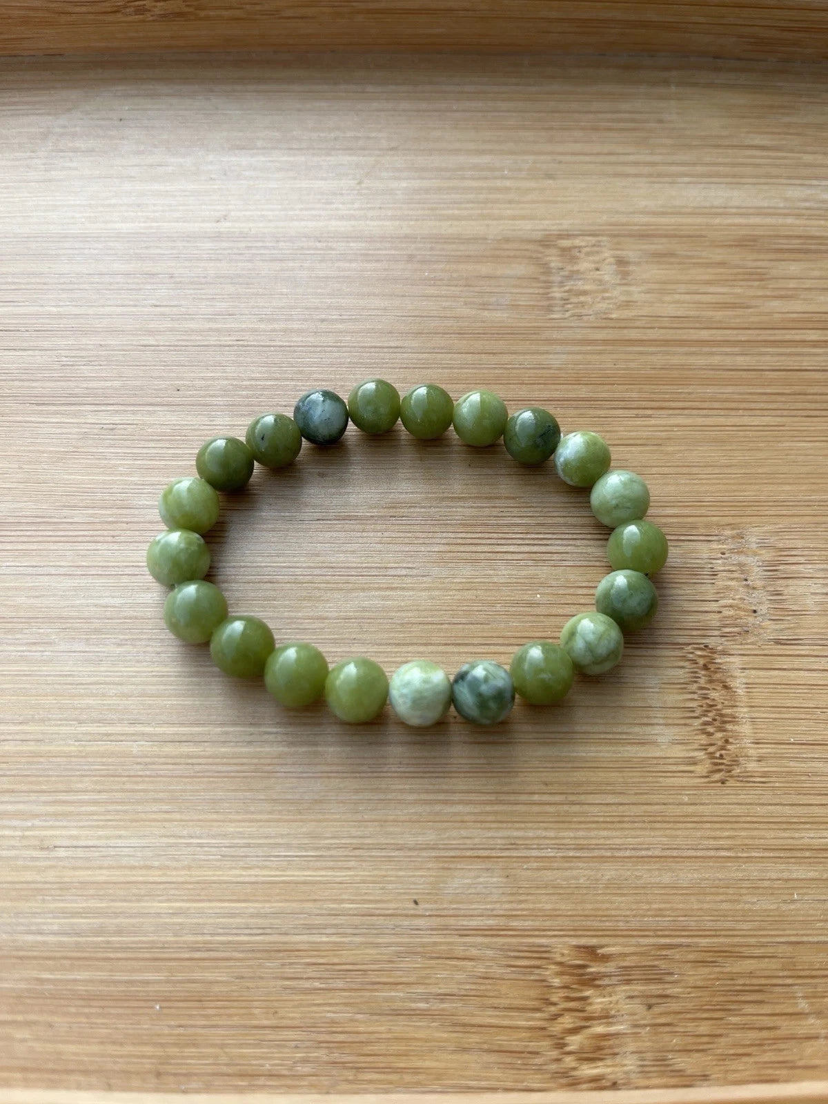 Green 8 mm round bead stretch bracelet - front view