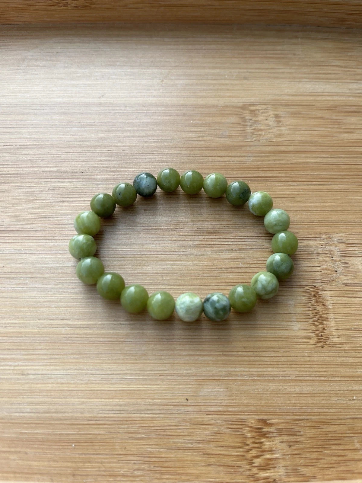 Green 8 mm round bead stretch bracelet - side view