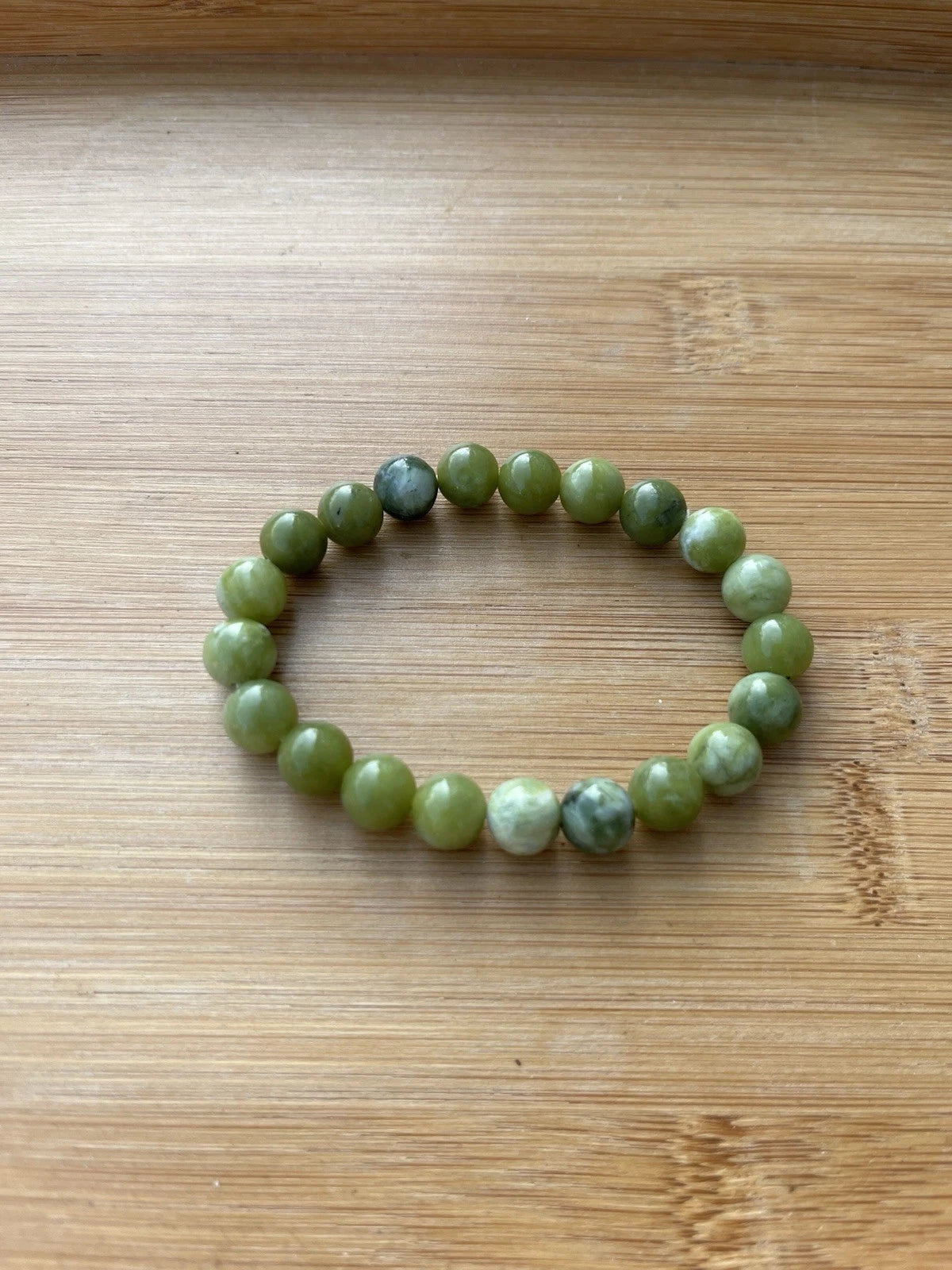 Green 8 mm round bead stretch bracelet - worn view
