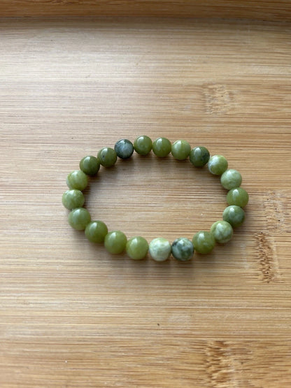 Green 8 mm round bead stretch bracelet - worn view